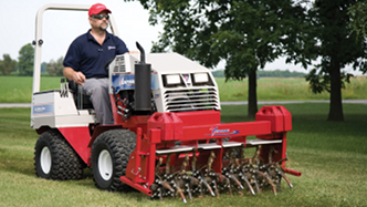 Ventrac compact tractor with aerator attachment