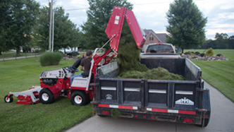 Dumping contents of the collection bin into a truck bed. Click for details.