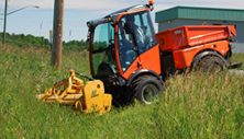 Holder tractor with rough cut flail mower carves park trail. Click image for details.