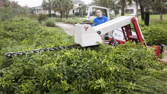 Ventrac boom mower trims those hard to reach places.