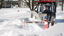 Ventrac 4500 with KX523 snowblower on city sidewalk. Click image for snowblower specs