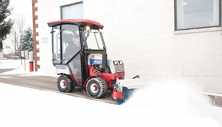 Ventrac 4500 clears sidewalk with broom. Click image to see broom specs.