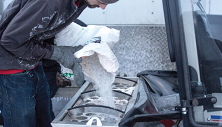 Loading de-icing product into Ventrac Drop Spreader. Click image to see Drop Spreader specs
