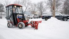 Ventrac 4500 with V-blade piling snow. Click image for V-blade specs