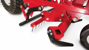 Close-up of edger and weed cutter on Ventrac baseball field renovator